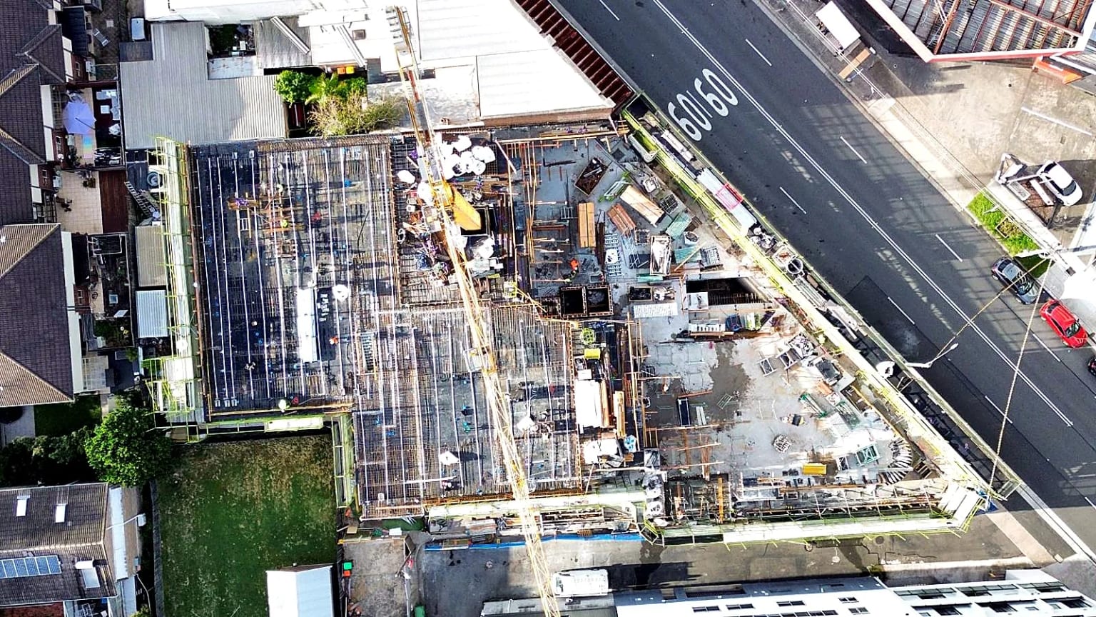 Aerial view of reinforcement, formwork and a tower crane across the site.
