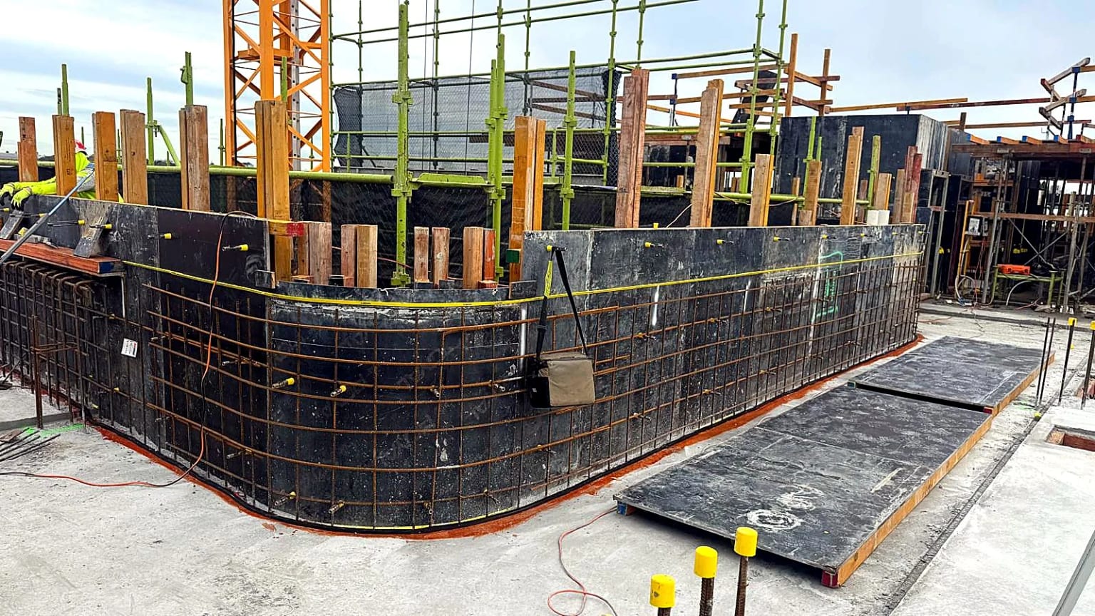 Curved wall formwork prepared with external reinforcing steel.