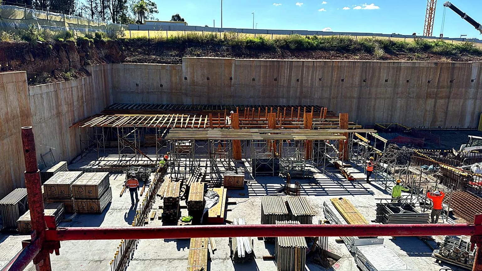 Site crew assembling bearers and shoring for the next slab section.