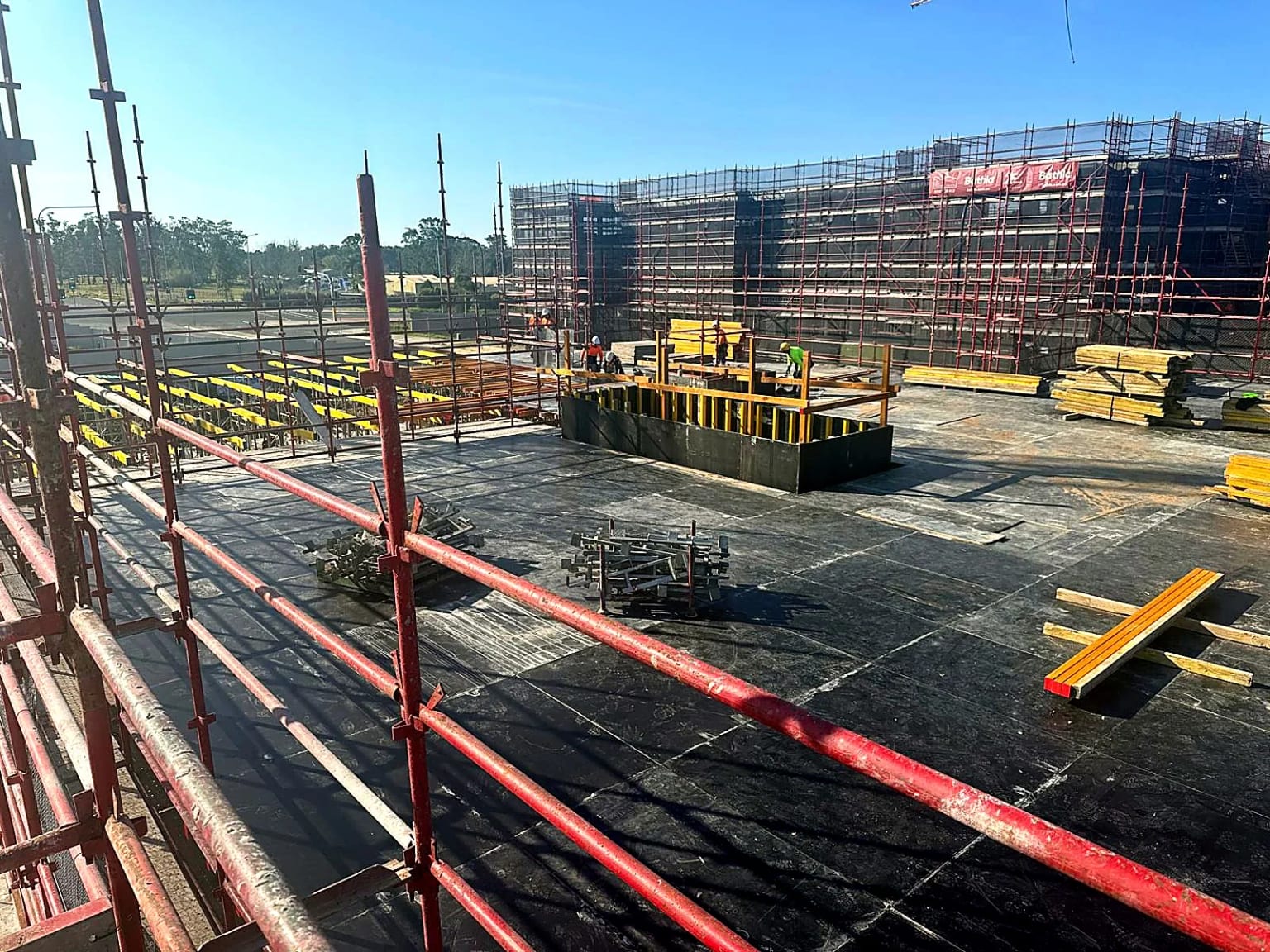 Installed formwork deck with materials and perimeter scaffolding.
